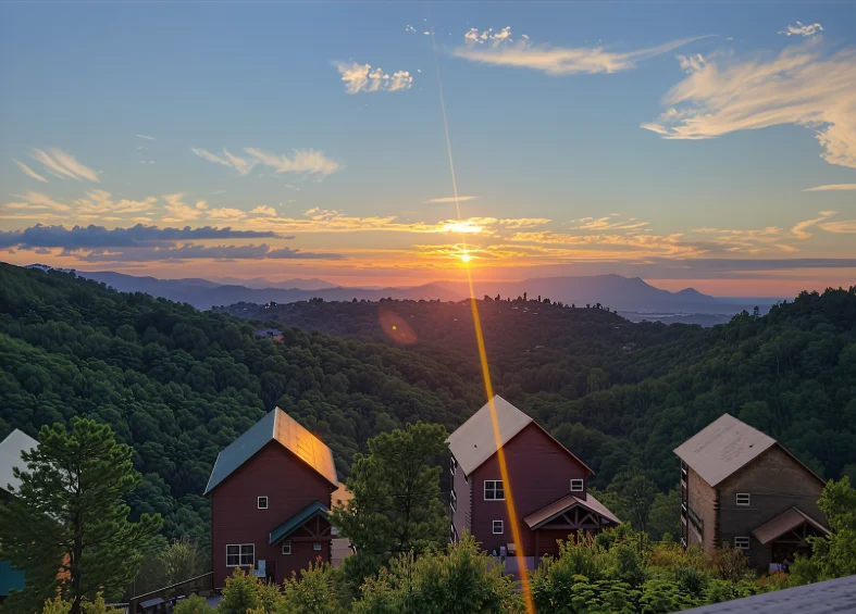 Affordable and Cosy Cabins in Pigeon Forge You’ll Love 3 Scenic sunset view of cabins in Pigeon Forge overlooking lush Smoky Mountains.