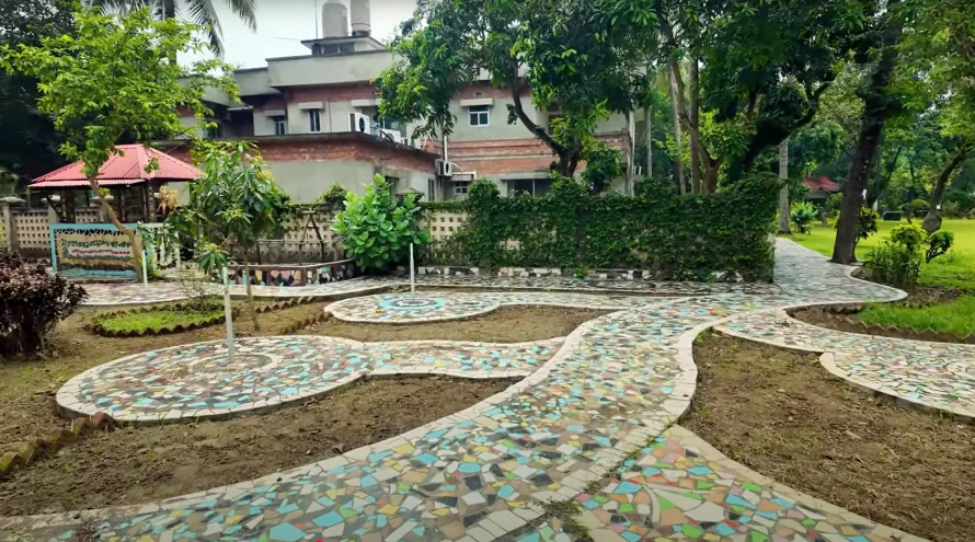 Best Resorts for Couples in Gazipur, Dhaka 23 Curved Mosaic-Tiled Walkways In A Landscaped Garden At Rangamati Waterfront Resort, Gazipur, Bangladesh, With Trees, Lawn, And A Red-Roofed Gazebo In The Background.