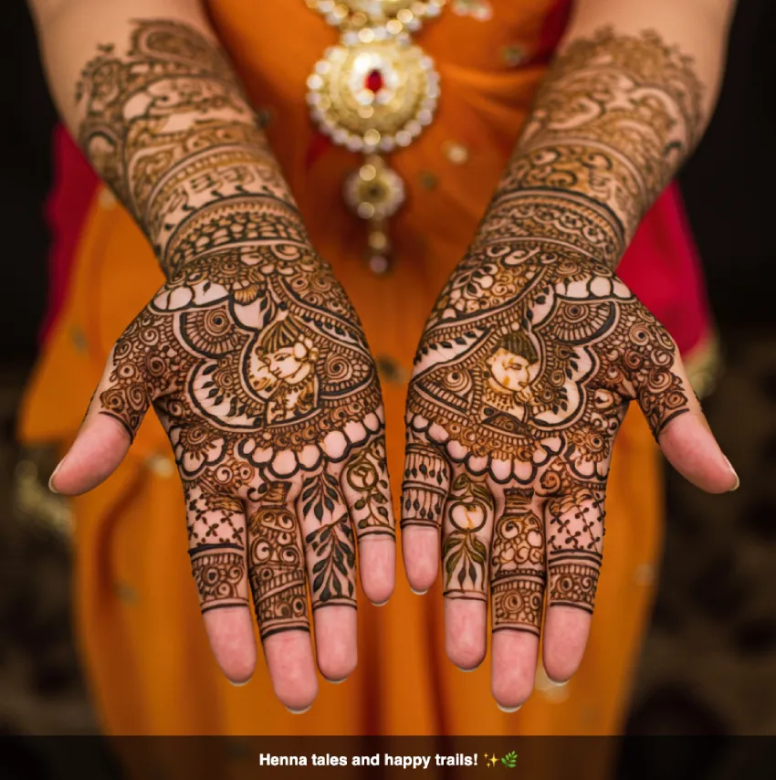 350+ Perfect Mehndi Captions for Instagram with Emojis 25 Hands with rich, traditional henna mehndi designs, conveying a story and timeless beauty, with the caption 'Henna tales and happy trails!