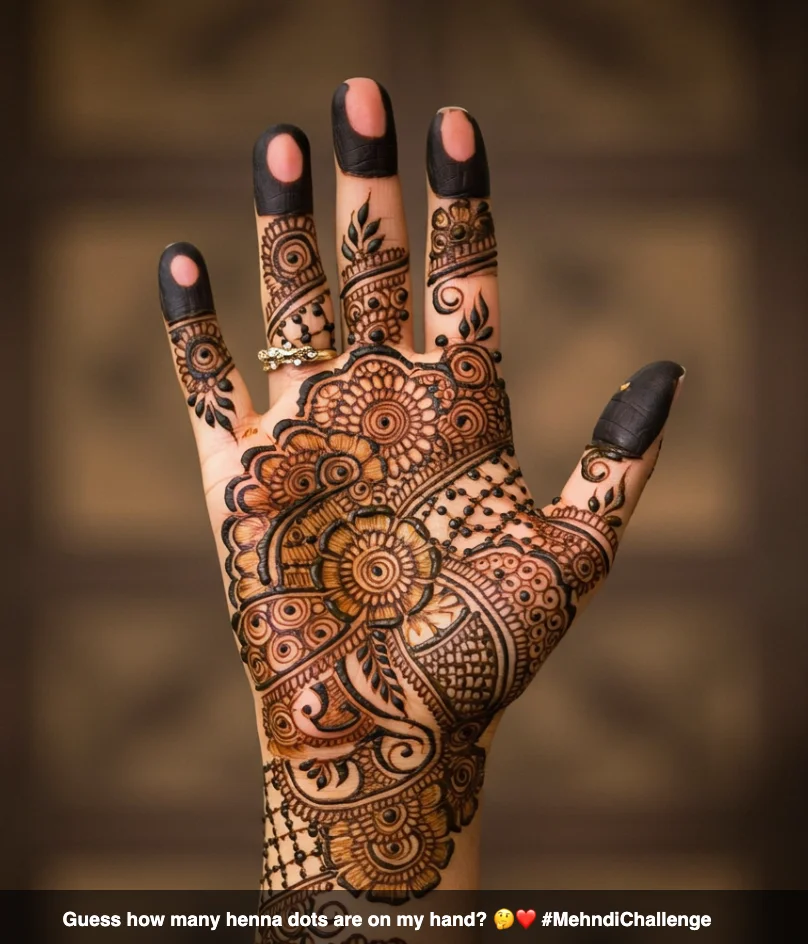 350+ Perfect Mehndi Captions for Instagram with Emojis 14 Hand with intricate mehndi designs, inviting interaction, with the caption 'Guess how many henna dots are on my hand? π€β€οΈ #MehndiChallenge'.