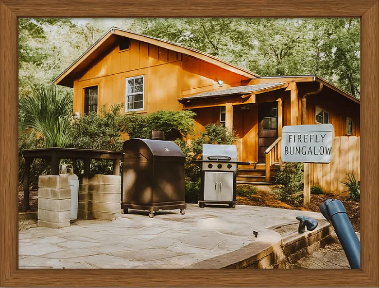 Affordable and Cosy Cabins in Pigeon Forge You’ll Love 7 Framed photo of Firefly Bungalow cabin surrounded by trees in Pigeon Forge