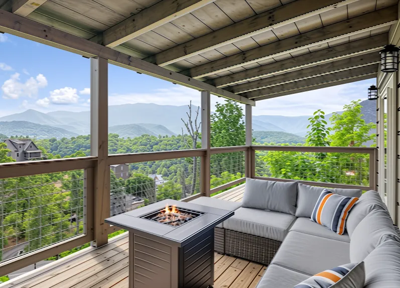 Affordable and Cosy Cabins in Pigeon Forge You’ll Love 10 Covered deck at Kelly’s Retreat cabin by Summit Cabin Rentals with fire pit, mountain views, and cozy seating in Pigeon Forge, Tennessee.