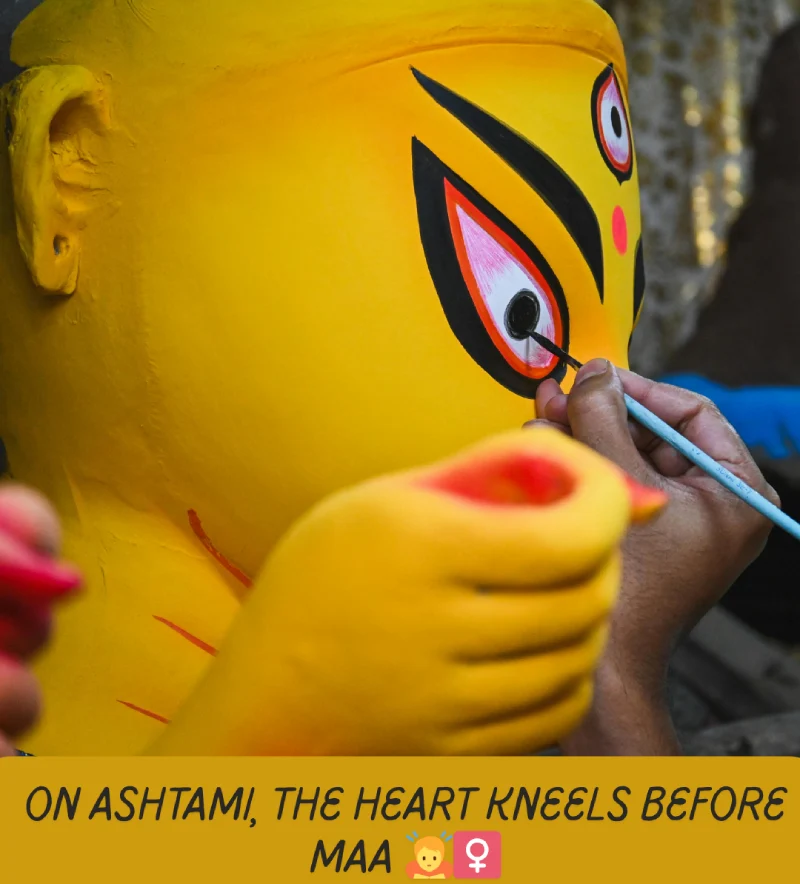 Best Durga Puja Captions, Wishes and Quotes for Social Media 4 A Close-Up Of An Artist'S Hand Carefully Painting The Eye Of A Yellow Durga Idol, With The Text &Quot;On Ashtami, The Heart Kneels Before Maa 🙏🏻♀️&Quot;.