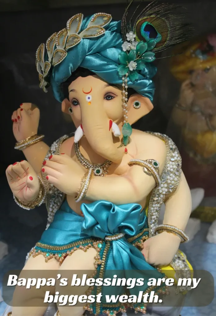 250+ Heartfelt Ganesh Captions for Instagram: Devotion, Joy & Blessings 9 A Beautifully Decorated Lord Ganesh Idol Wearing A Turquoise Turban And Jewelry, With The Words &Quot;Bappa'S Blessings Are My Greatest Wealth.&Quot;