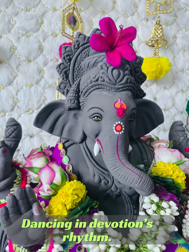 250+ Heartfelt Ganesh Captions for Instagram: Devotion, Joy & Blessings 12 A Gray Statue Of Lord Ganesh Decorated With Colorful Flowers, With The Text &Quot;Dancing In Devotion'S Rhythm.&Quot;