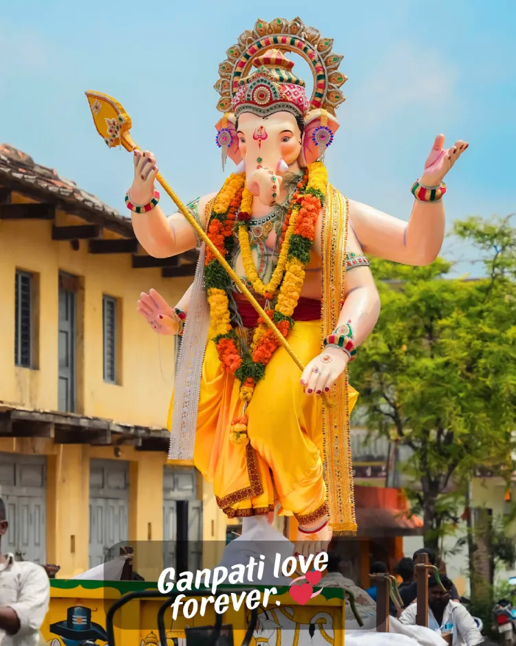 250+ Heartfelt Ganesh Captions for Instagram: Devotion, Joy & Blessings 3 A Large, Colorful Statue Of Lord Ganesh Decorated With Marigold Garlands Is Being Carried Through The Street In A Festive Procession. The Words &Quot;Ganpati Love Forever&Quot; Are Written At The Bottom Of The Image.