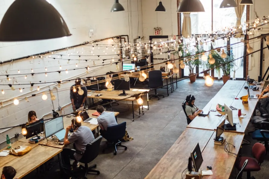 Understanding AI Integration: Transforming Business Processes for the Digital Age 1 A Busy Office Environment Featuring Individuals At Desks, Collaborating On Ai Integration Strategies For Modern Businesses.